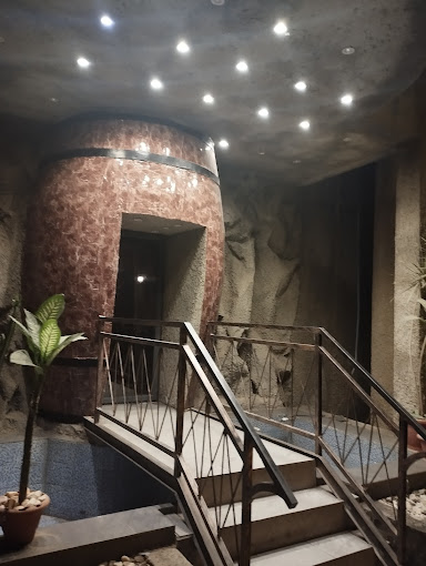 Stairwell with stone walls leading into the dining cave