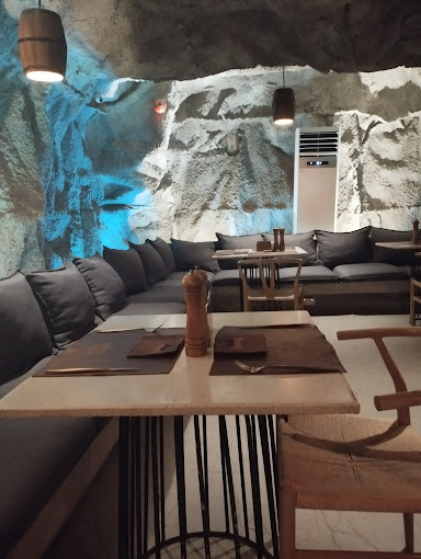 Cave booth seating with hand-sculpted blue-lit walls